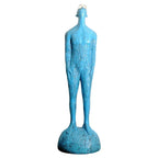 A tall slender blue velvet sofa cushion with textured surface and rounded base ideal for living room home decor