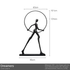 Black metal sculpture of a figure holding a circular hoop labeled dreamers enhances living room home decor