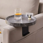 Gray marble-textured round sofa tray table with black metal arm attached to sofa for small spaces use