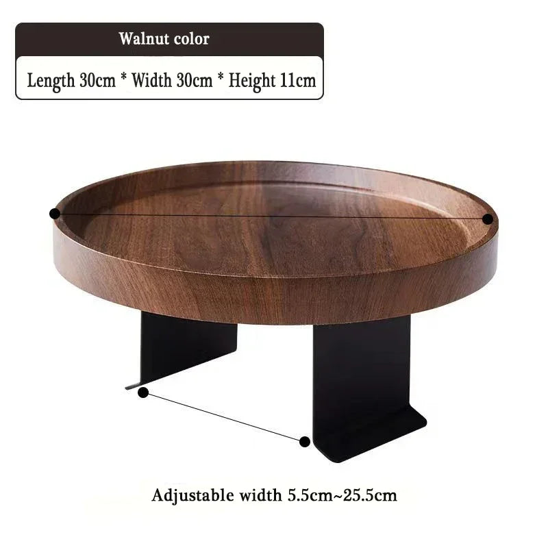 Walnut-colored round wooden sofa tray table with black metal legs designed for small spaces