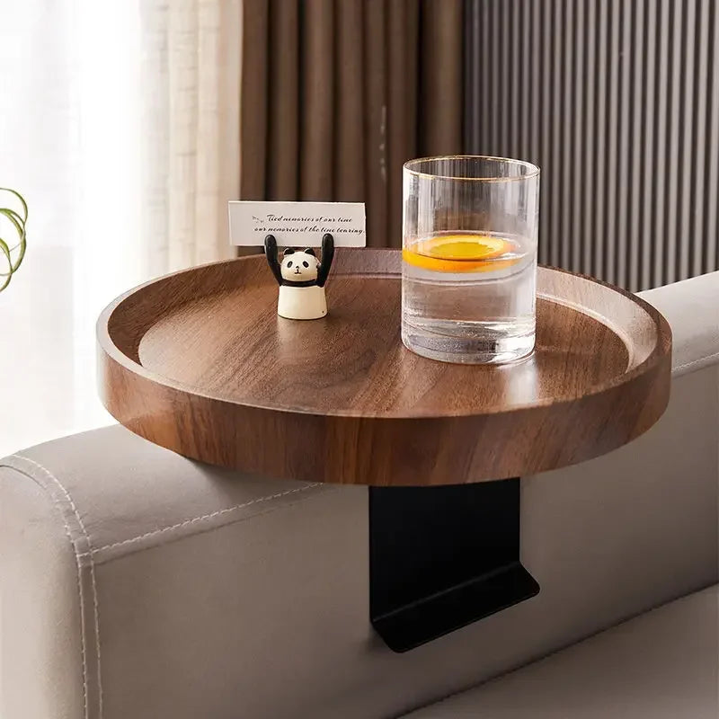A sleek round wooden sofa tray table with dark brown finish and black metal clamp for small spaces