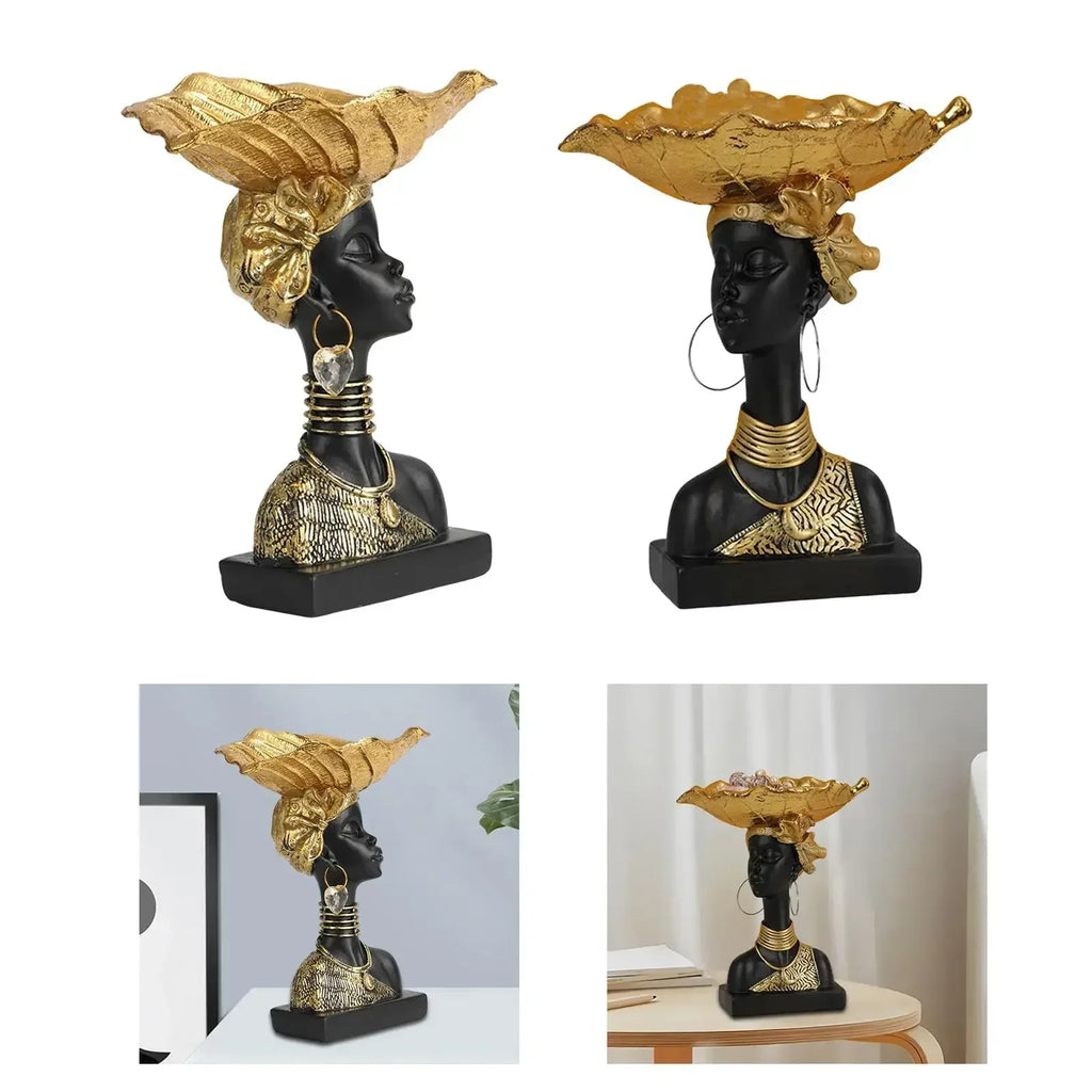 Black resin bust with gold leaf headdress and jewelry accents on decorative wooden modern style storage tray