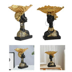 Black resin bust with gold leaf headdress and jewelry accents on decorative wooden modern style storage tray