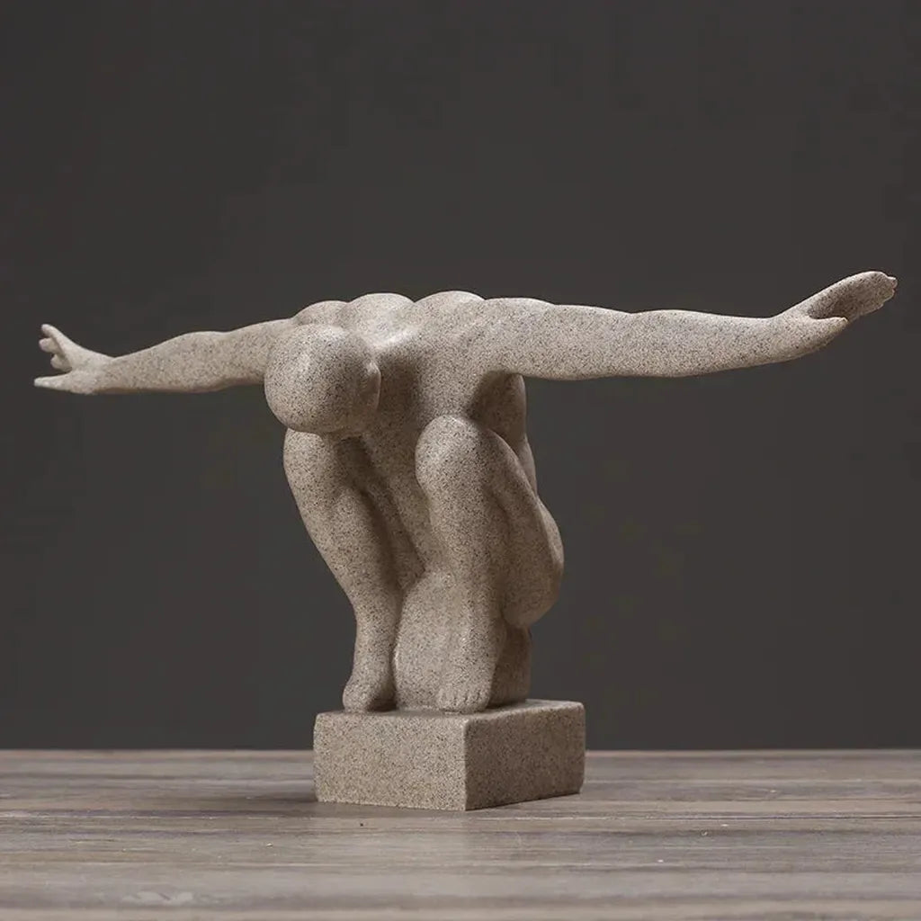Gray stone thinker statue in a dynamic crouching pose made of nordic resin for modern nordic decor and home decor
