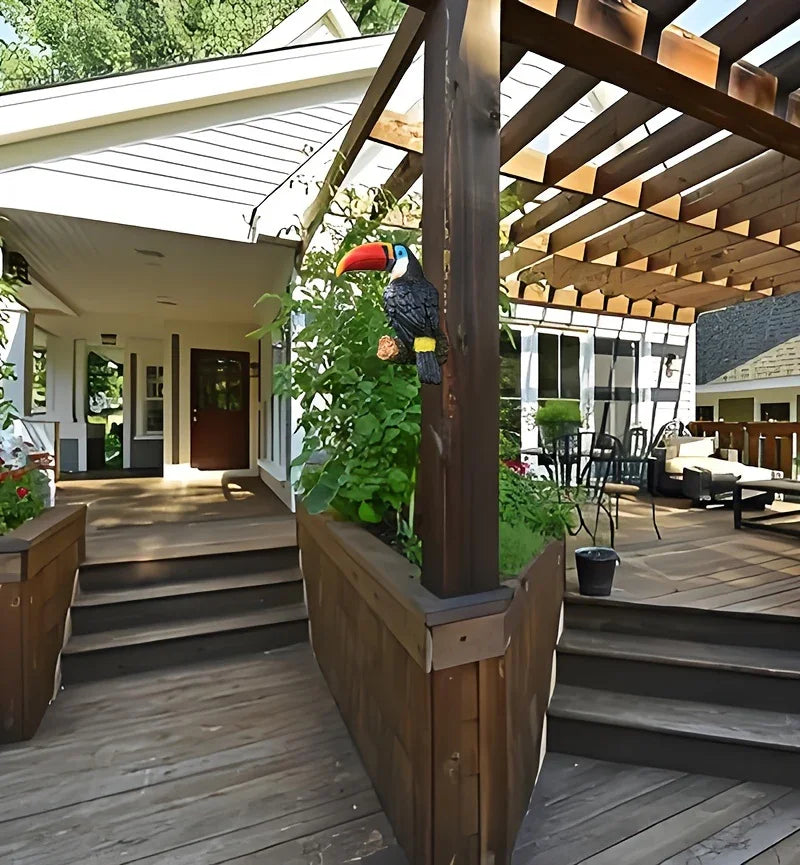 Outdoor patio with wooden pergola, plants, and a decorative parrot on a柱子