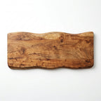 Wooden cutting board with a wavy edge on a white background