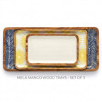 Three nested rectangular wood serving trays with rounded corners, shown on a white background. The center tray is solid off-white, while the outer trays feature navy blue and yellow sunburst and chevron patterns.