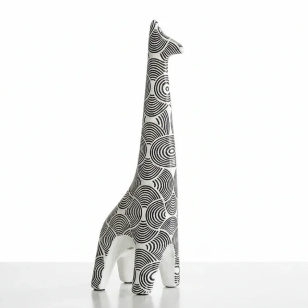 Decorative giraffe figurine with black and white pattern on a white background