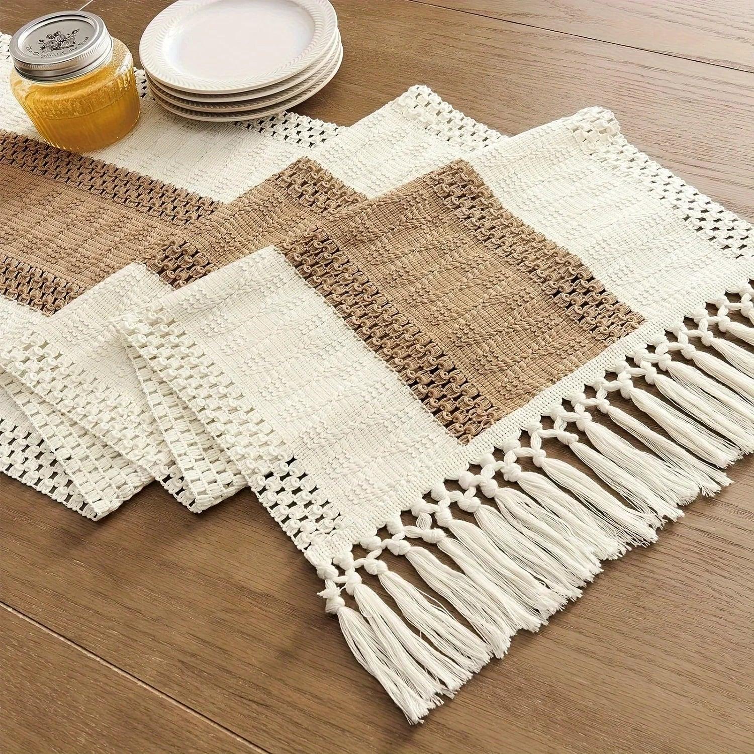 Cream and brown striped bohemian table runner with macrame crochet details and tassels on a wooden table.