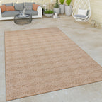 Beige Captera rug with Aztec geometric pattern on a modern outdoor patio.