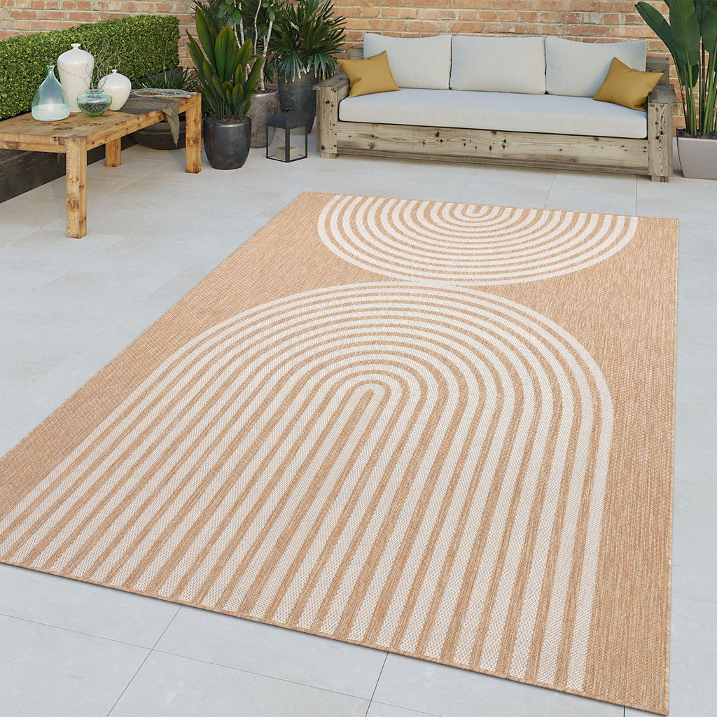 Nature beige indoor outdoor rug with white minimalist arch line pattern on a stone patio.