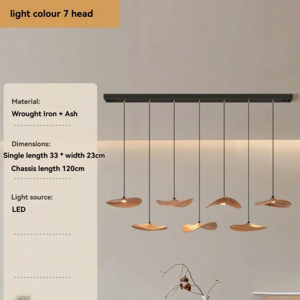 Modern pendant light fixture with hanging lights on a neutral background