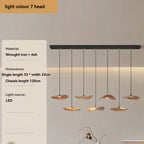 Modern pendant light fixture with hanging lights on a neutral background