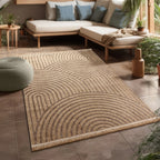 Beige and brown indoor outdoor rug with modern concentric circle pattern and fringe detail in a sunroom.