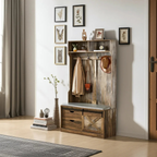 Wooden entryway console with coat rack and bench in a room with framed artwork on the wall.