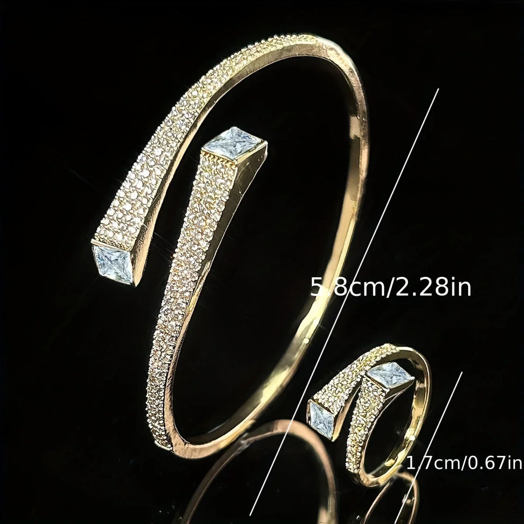 Gold-tone open bracelet and ring set featuring shiny irregular geometric synthetic zirconia stones.
