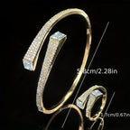 Gold-tone open bracelet and ring set featuring shiny irregular geometric synthetic zirconia stones.