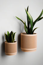 White ceramic hanging planter with streaming water design, wall-mounted - House of Avana