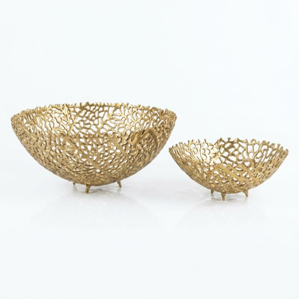 Two gold decorative bowls with intricate designs on a white background