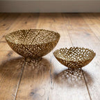 Two gold decorative bowls on a wooden floor [[SKU:HOA-MOR-KIT-027]]