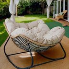 Brown rattan outdoor sofa with beige weather-resistant cushions - House of Avana