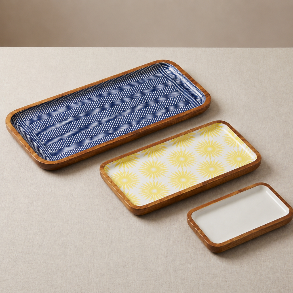 Three rectangular ceramic trays with different patterns on a beige surface