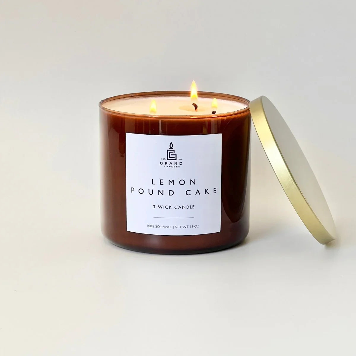 White ceramic candle with sweet lemon scent, soft glow - House of Avana