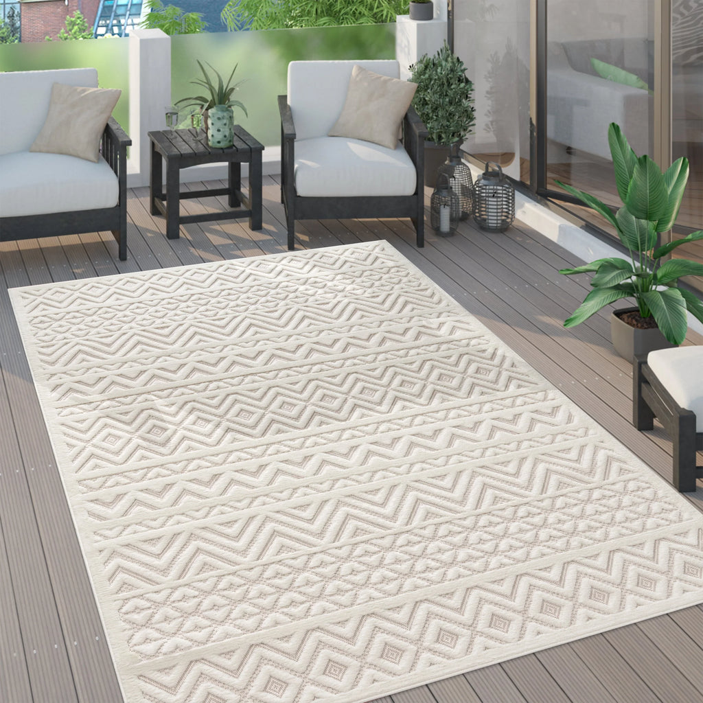 Cream Livorno indoor outdoor rug with boho high-low geometric pattern on a wooden patio deck.