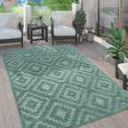 Turquoise trellis pattern high-low textured rug on a modern outdoor wooden deck with patio furniture.