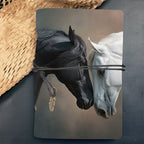 Luxury leather notebook with black and white horse watercolor art and a bronze feather charm cord closure.
