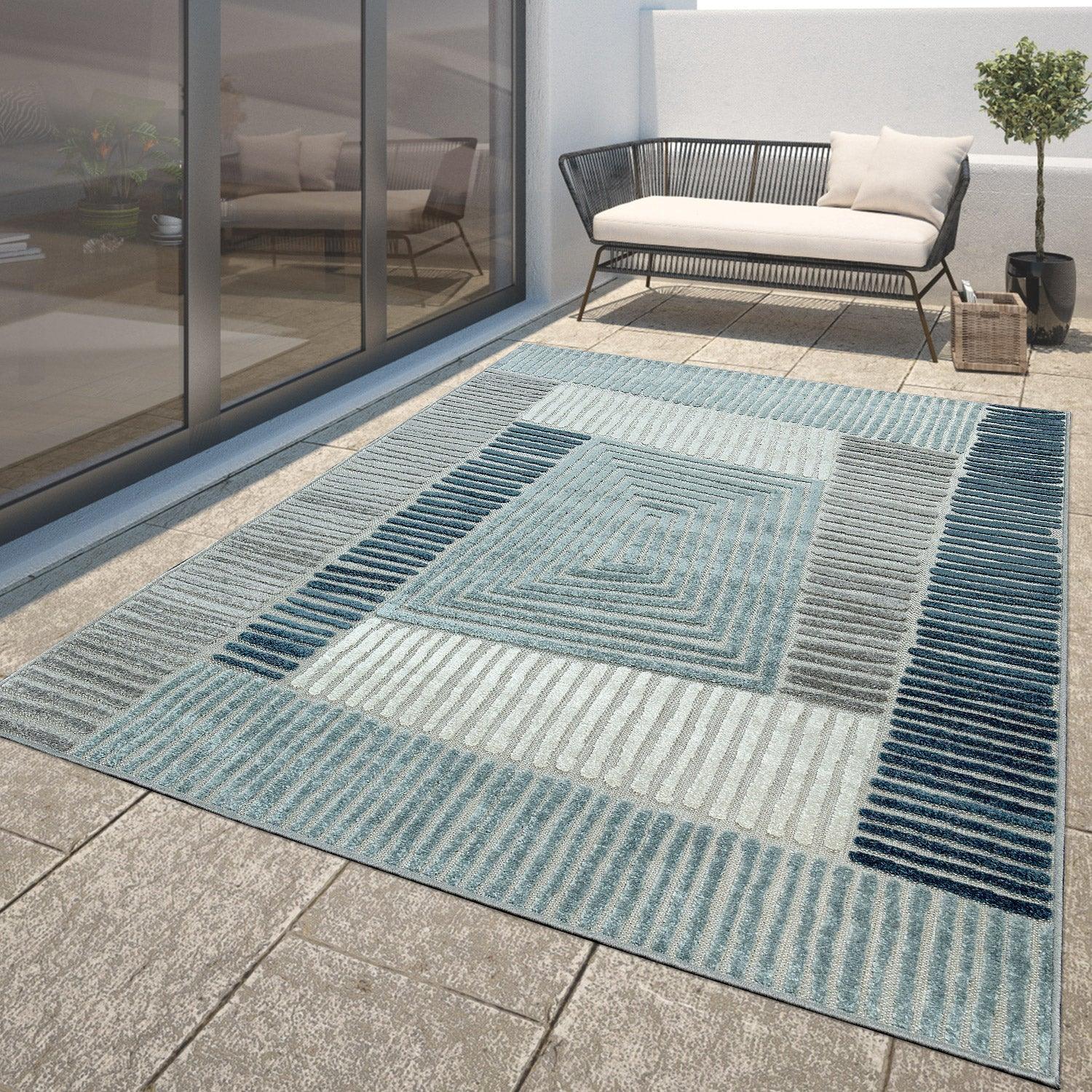 Aqua blue Marrakesh carved design indoor and outdoor rug on a modern patio.
