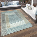 Marrakesh indoor outdoor rug with blue and brown carved geometric pattern on a wooden patio deck.