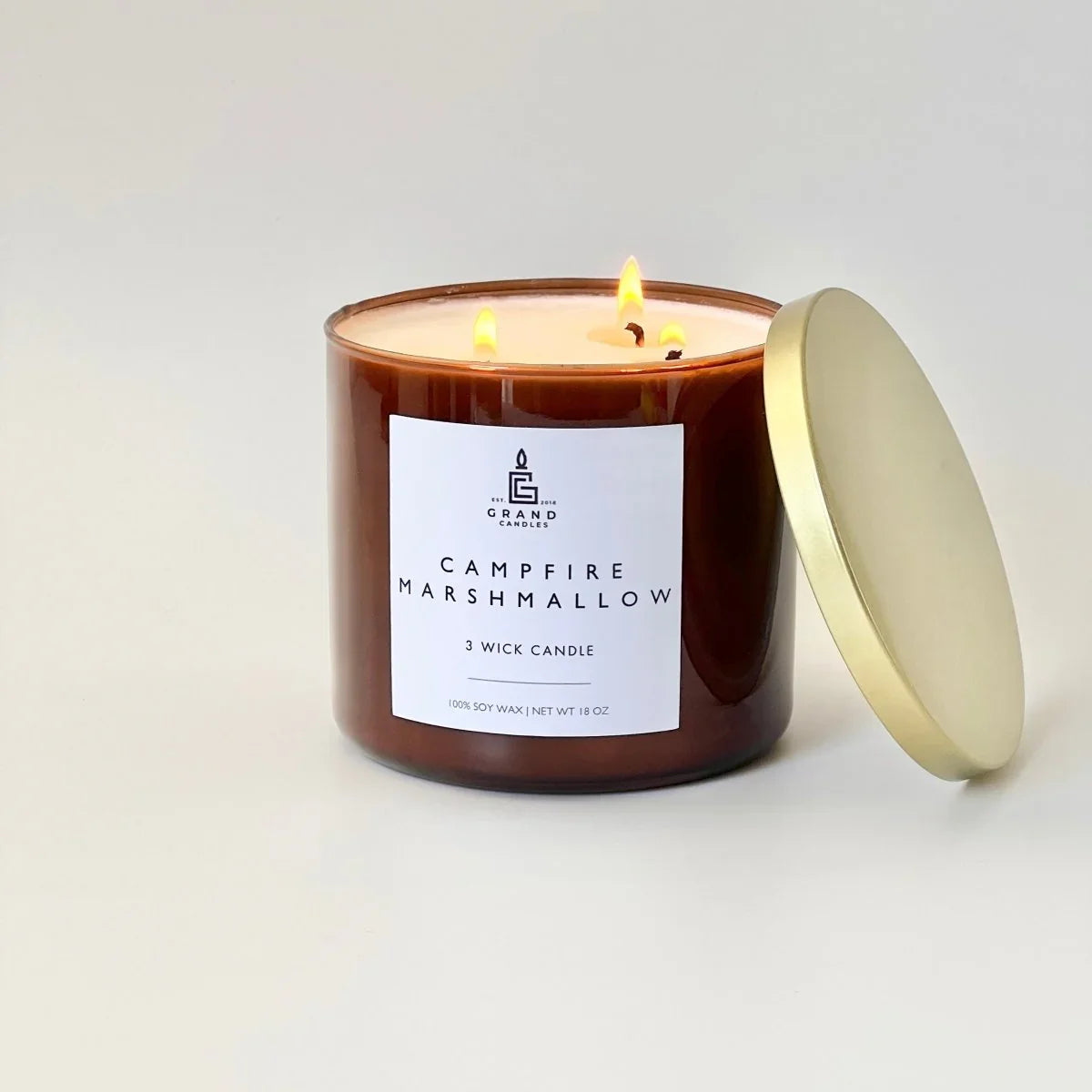 White ceramic candle with golden lid, soft glow Campfire Marshmallow scent - House of Avana