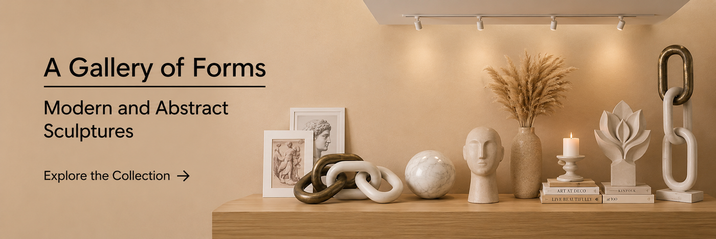 Modern abstract sculptures displayed on a wooden shelf with minimalist home décor in a warm contemporary interior.