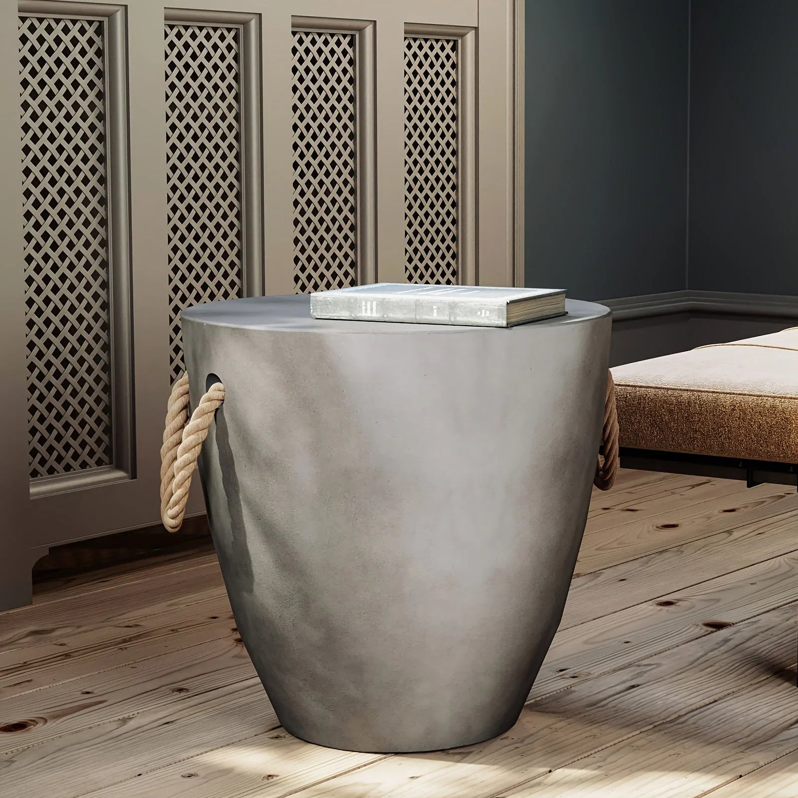 Modern light gray drum-shaped end table with rope handles and a faux slate top in a home setting.