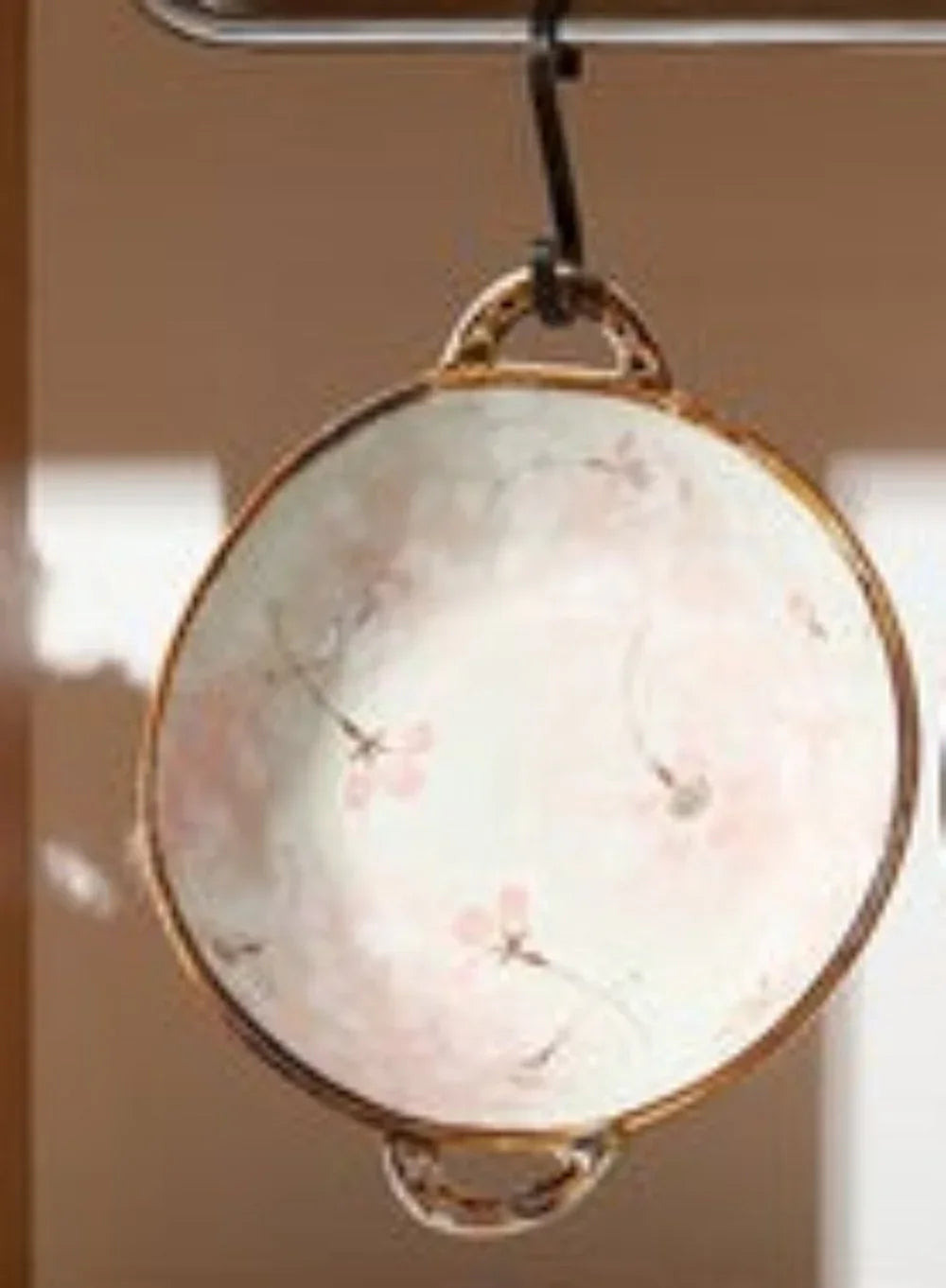 Delicate porcelain noodle bowl with gold rim and pink floral patterns for an elegant dining experience and table settings