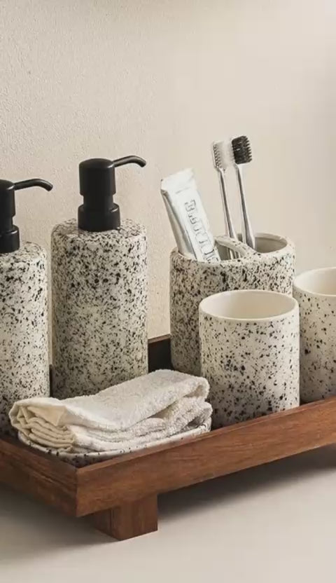 Terrazzo bathroom accessories set with soap dispenser, toothbrush holder and towels on wooden tray - House of Avana bathroom collection