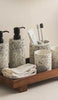Terrazzo bathroom accessories set with soap dispenser, toothbrush holder and towels on wooden tray - House of Avana bathroom collection