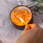 Sage green soy wax candles in crystal clear glass jars with dried botanicals, 12+ hour burn time - House of Avana