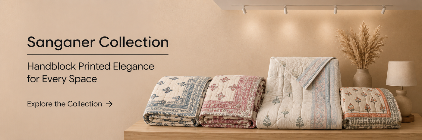 Sanganer handblock printed bedding collection featuring premium quilts and home décor in a warm minimalist interior.