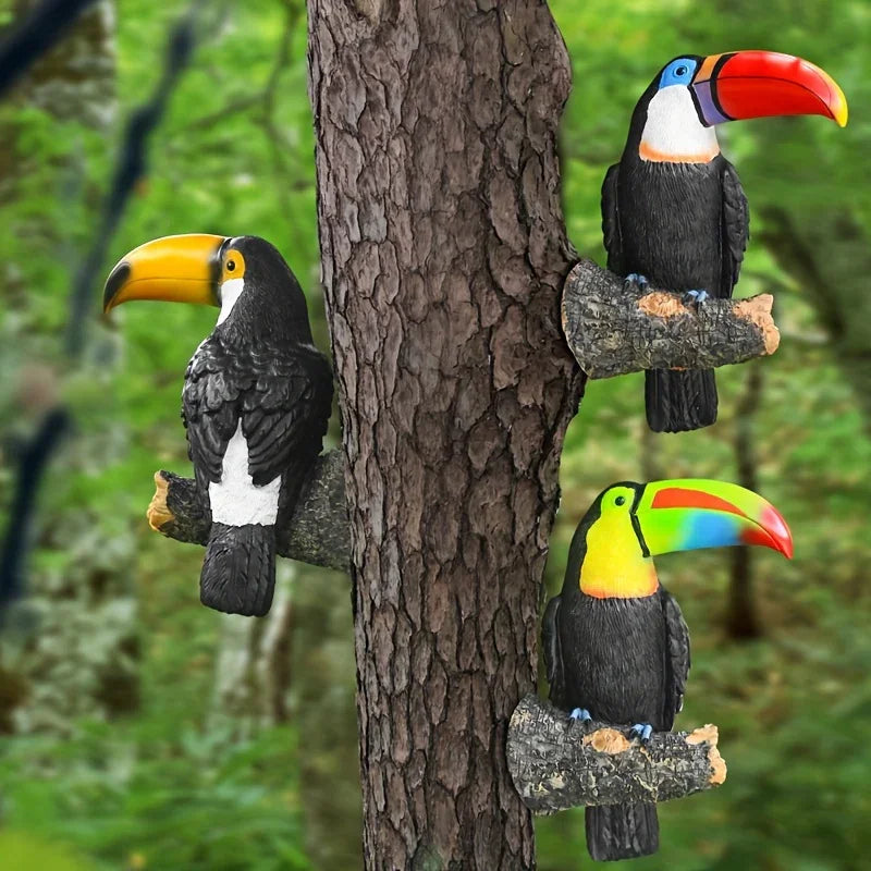 Three colorful toucan figurines perched on a tree branch with a forest background.
