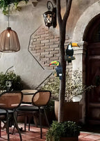 Outdoor patio area with tables, chairs, and decorative toucan figures.
