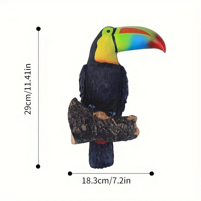 Colorful toucan figurine on a branch with measurements on a white background