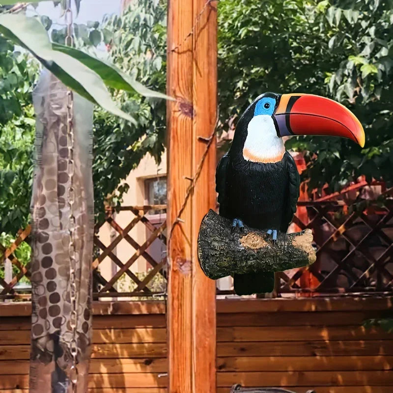 Decorative toucan bird on a wooden post with a garden background
