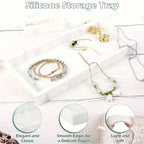 Silicone storage tray with jewelry on a white wooden surface