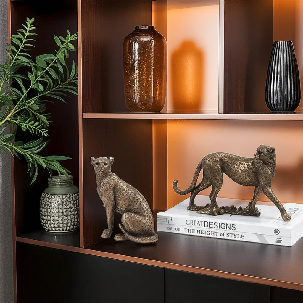 Decorative shelf with animal figurines, vases, and books on a wooden shelf.
