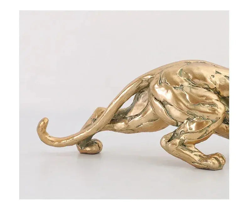 Golden metallic panther sculpture with textured sculpted surface and sleek elongated form abstract gold panther figurine