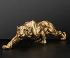 Golden metallic panther sculpture with detailed musculature in an abstract gold panther design for modern decor