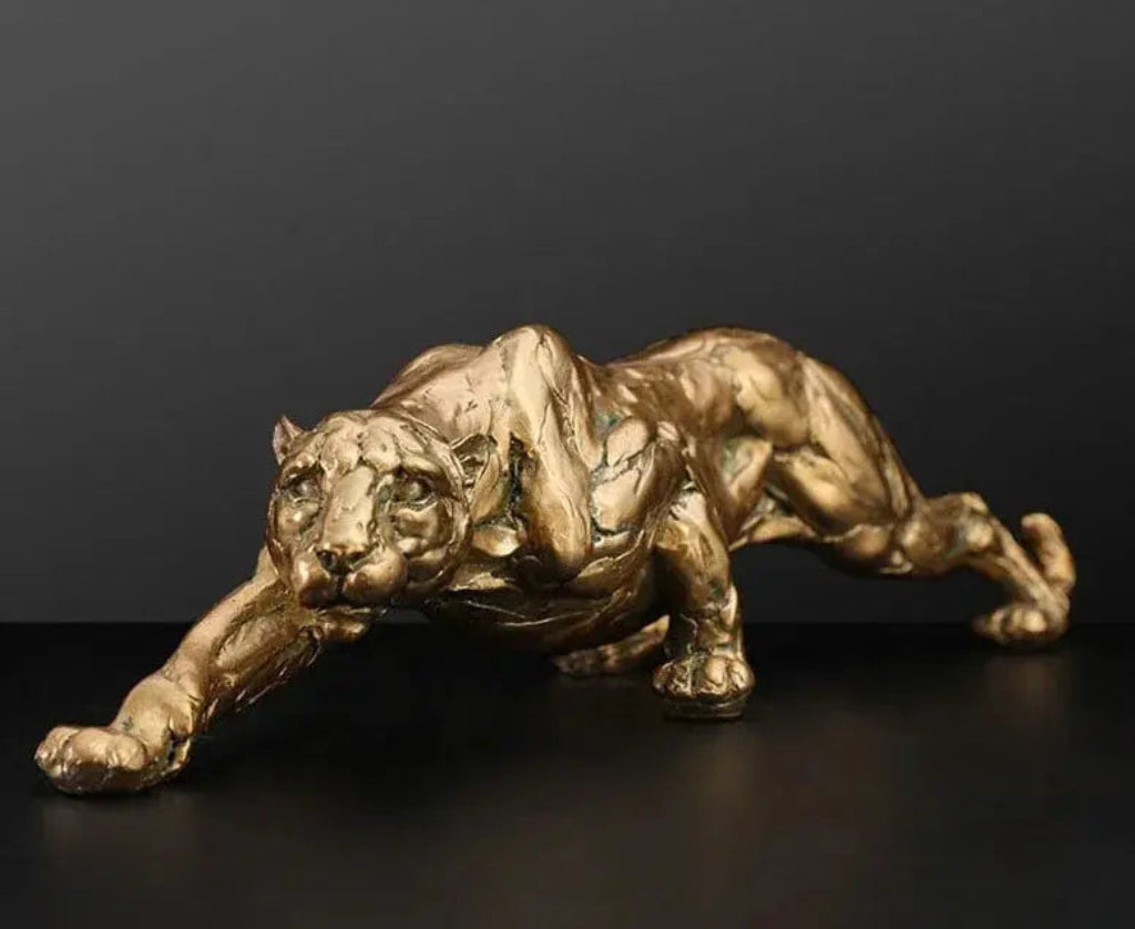 Golden metallic panther sculpture with detailed musculature in an abstract gold panther design for modern decor