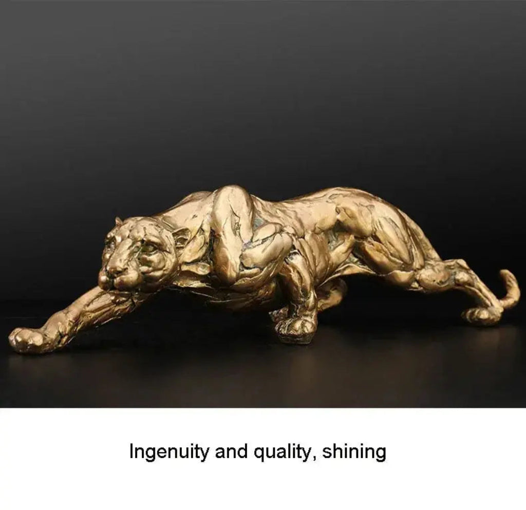 Gold panther sculpture with detailed musculature in a sleek dynamic pose for modern abstract decor